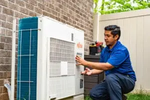 HVAC technician in Murfreesboro performing AC repair and summer HVAC maintenance for energy efficiency