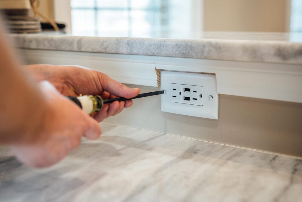 Residential Electrician fixing outlet
