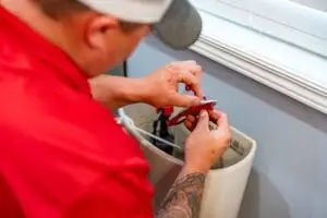 Airstream employee doing maintenance on a toilet.
