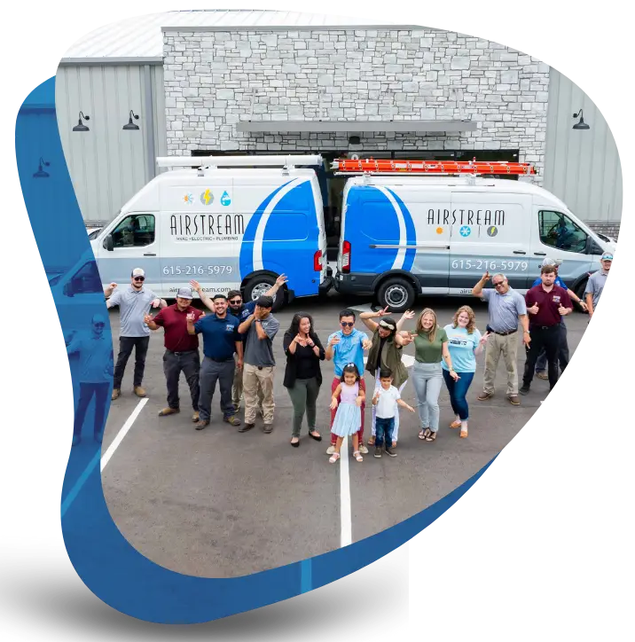 The Airstream Plumbing, Heating & Air team and their families posing proudly in front of branded service vans.