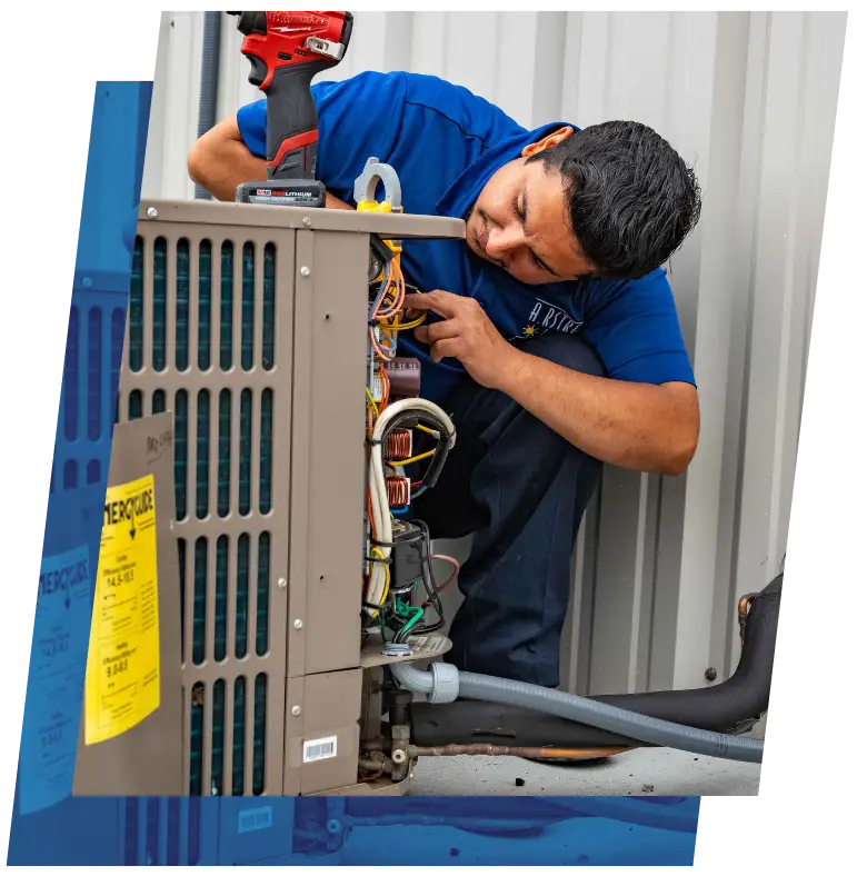 HVAC technician diagnosing an outdoor air conditioning unit with a power drill.