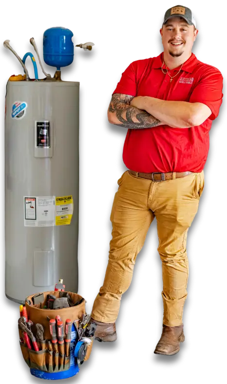 Smiling Airstream technician in red shirt with arms crossed, standing next to a water heater and a bucket of tools.