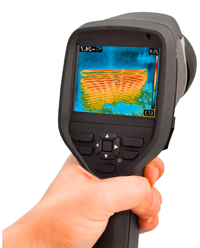 A hand holding a thermal imaging camera displaying a colorful heat signature, indicating electrical diagnostics.