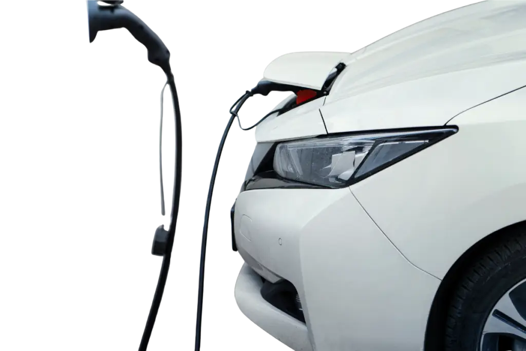 A white electric vehicle (EV) charging from a charging station, showing the charging port connected.