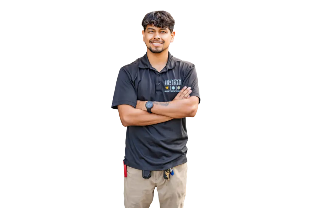 Smiling Airstream Plumbing, Heating & Air technician in a black uniform shirt with arms crossed, ready for service.