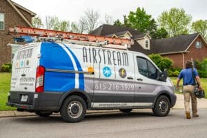 Airstream Services electrician van parked in a Smyrna, TN neighborhood with a technician walking toward a home.