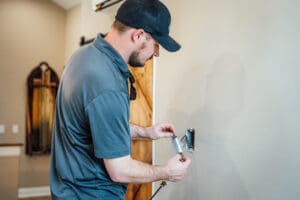 Electrician repairing electrical outlet in a Nashville home